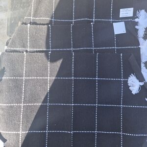Black and White Checkered Rug with Tassels